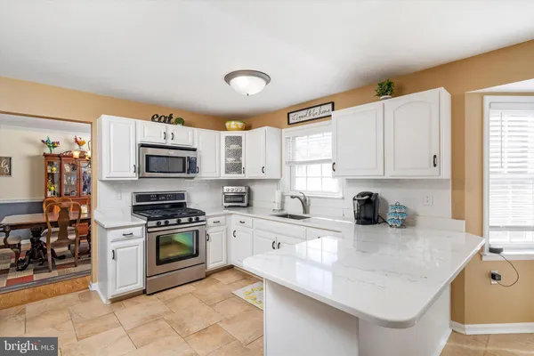 a kitchen with stainless steel appliances a refrigerator a stove and a sink
