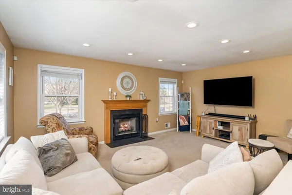 a living room with a fireplace and a window