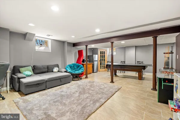 a room with furniture pool table and window