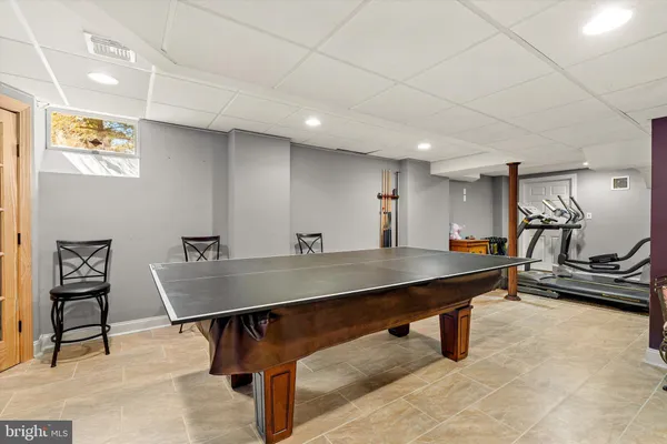 a view of a patio with table and chairs and potted plants