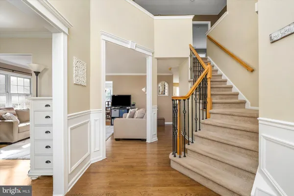 a view of a hallway view with staircase and living room