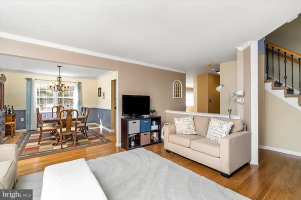 a view of a dining room with furniture and chandelier