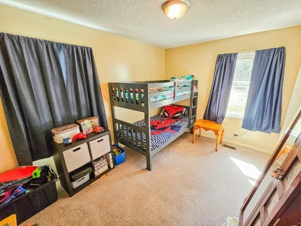 a bedroom with furniture and a wooden floor