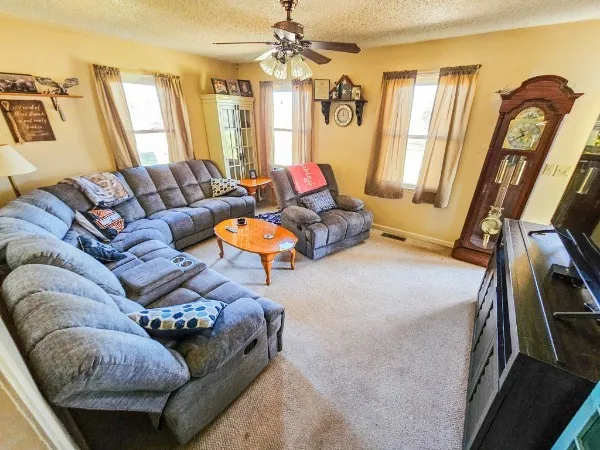 a living room with furniture and a chandelier