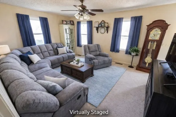 a living room with furniture and a mirror
