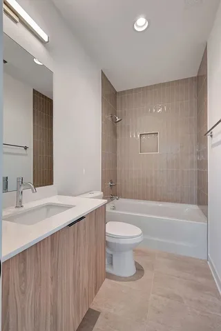 a bathroom with a sink a toilet and bathtub