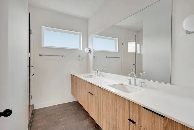 a bathroom with a double vanity sink and mirror