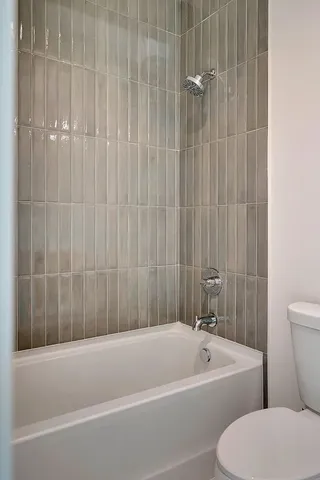 a bathroom with a toilet a sink and bathtub