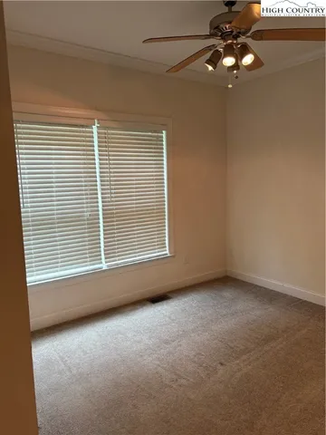 a view of a livingroom with a ceiling fan and window