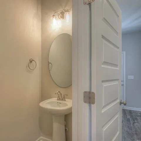 a bathroom with a sink a mirror and shower