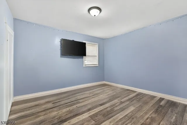 a view of room with wooden floor and window