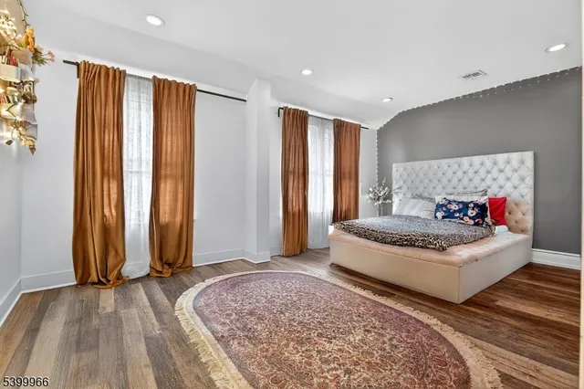 a spacious bedroom with a bed and a window