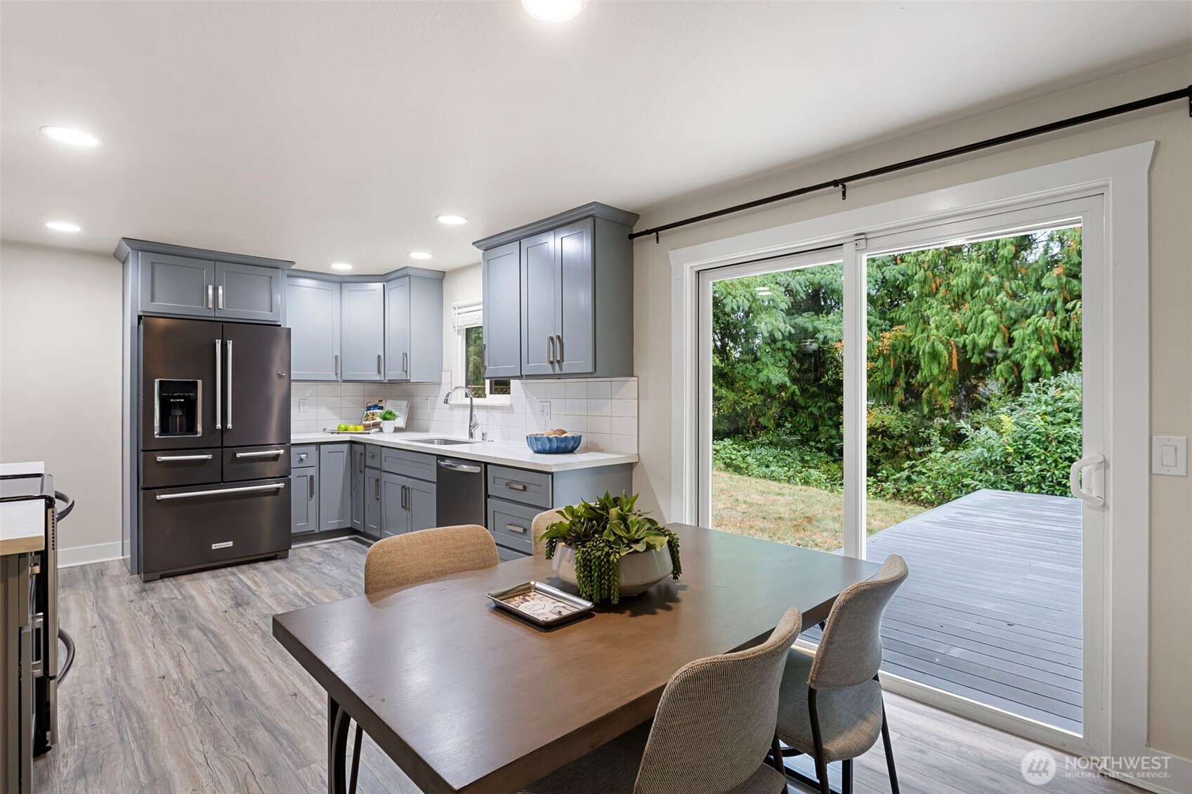 11705 Silver Way Everett, WA 98208 - Photo 7 of 26 a kitchen with refrigerator cabinets dining table and chairs