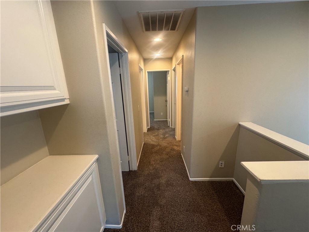 9757 Edenbrook Drive Riverside, CA 92503 - Photo 15 of 40 a view of a hallway with washer and dryer