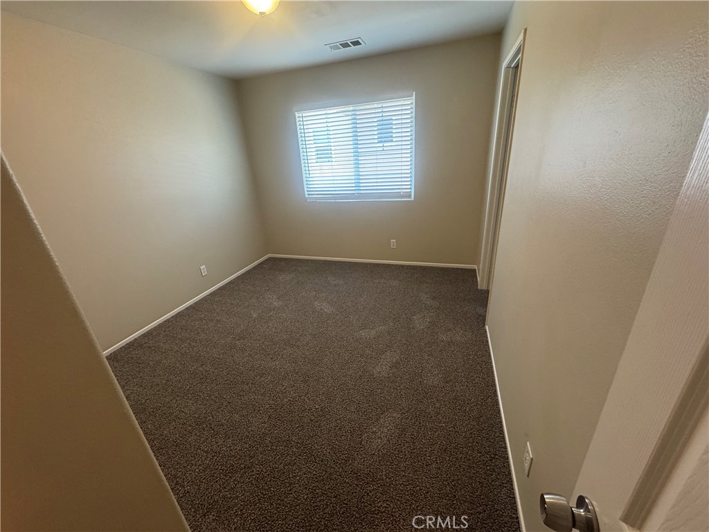 9757 Edenbrook Drive Riverside, CA 92503 - Photo 16 of 40 an empty room with a window