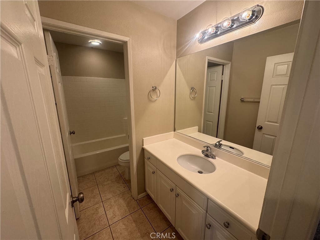 9757 Edenbrook Drive Riverside, CA 92503 - Photo 18 of 40 a bathroom with a sink a mirror and a shower