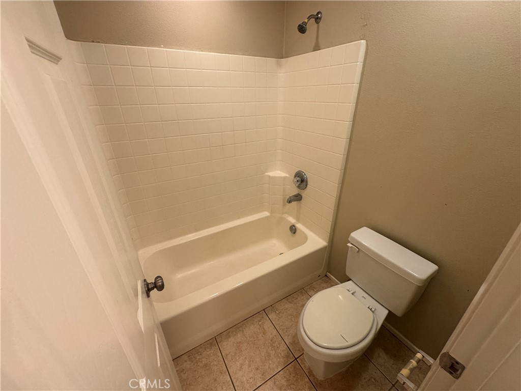 9757 Edenbrook Drive Riverside, CA 92503 - Photo 20 of 40 a white toilet and tub sitting next to a bathroom sink