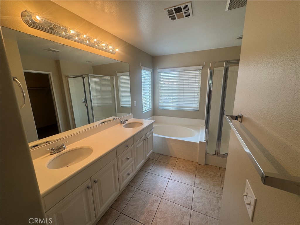 9757 Edenbrook Drive Riverside, CA 92503 - Photo 29 of 40 a spacious bathroom with a tub sink and mirror
