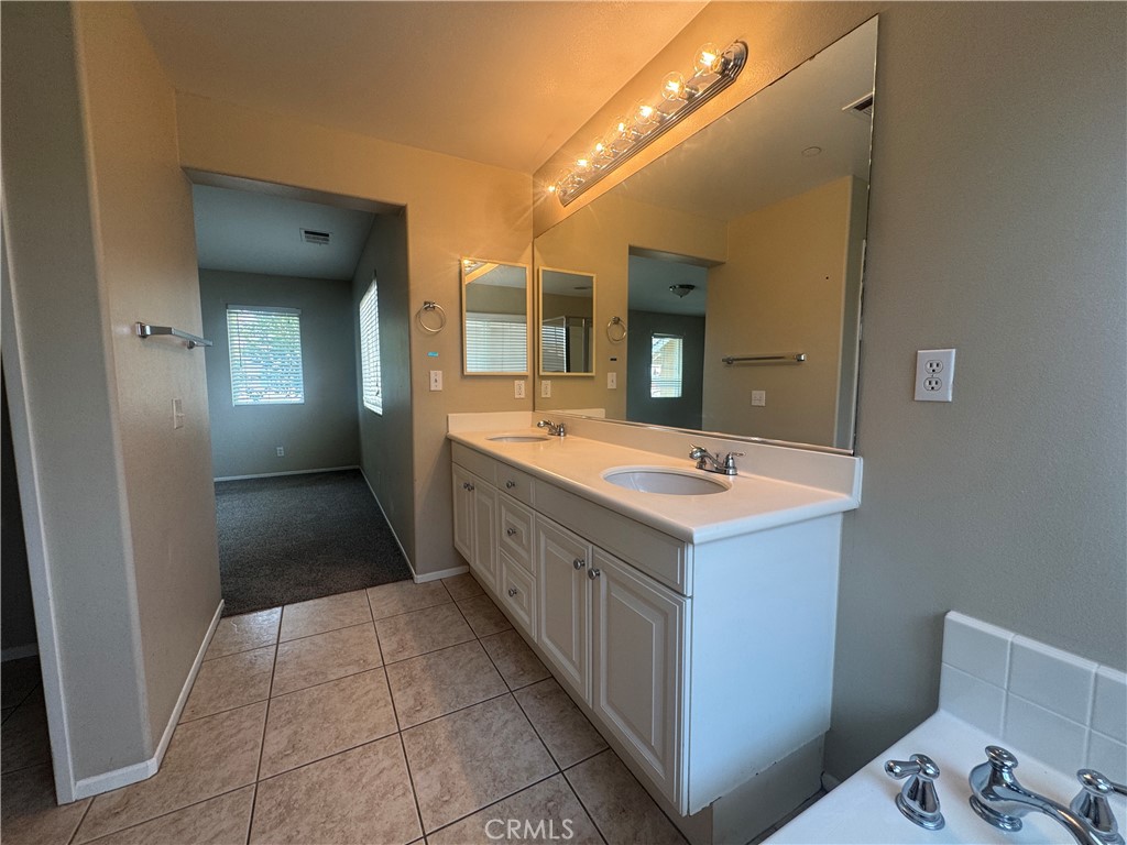 9757 Edenbrook Drive Riverside, CA 92503 - Photo 30 of 40 a bathroom with a double vanity sink and mirror