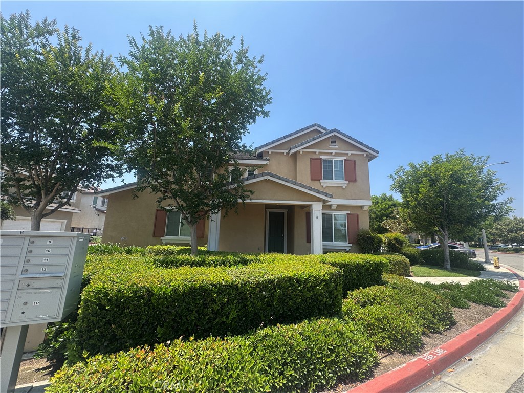 9757 Edenbrook Drive Riverside, CA 92503 - Photo 3 of 40 a front view of a house with a yard