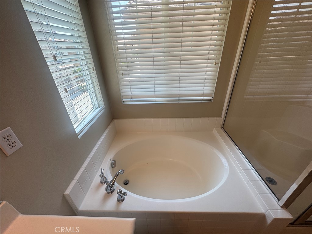 9757 Edenbrook Drive Riverside, CA 92503 - Photo 31 of 40 a bath tub sitting in a bathroom next to a window