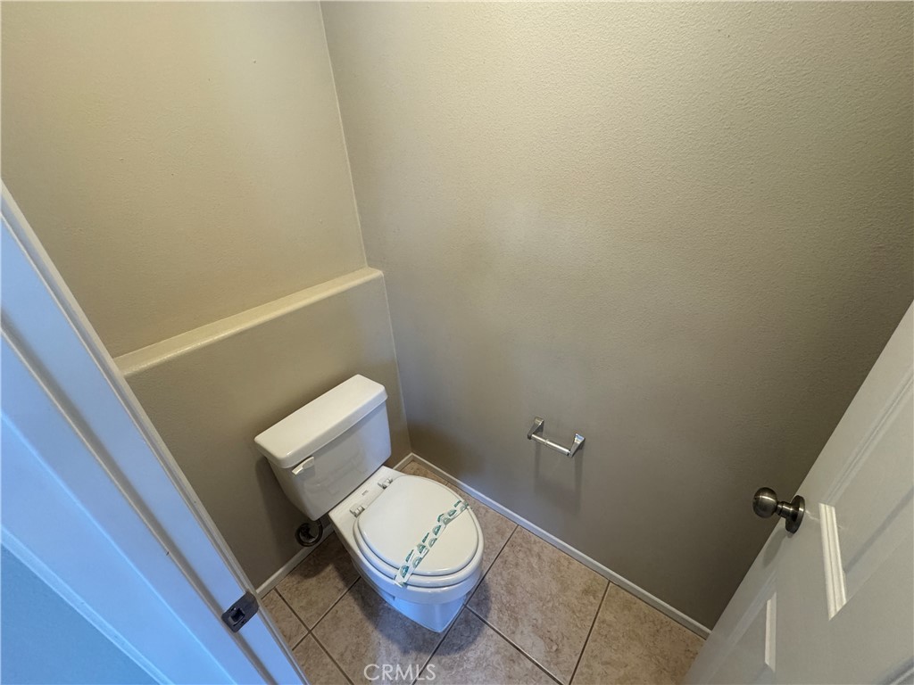 9757 Edenbrook Drive Riverside, CA 92503 - Photo 33 of 40 a white toilet sitting next to a shower