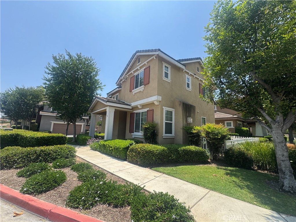 9757 Edenbrook Drive Riverside, CA 92503 - Photo 4 of 40 a front view of a house with a garden