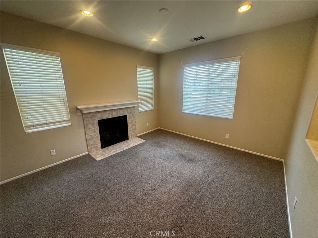 9757 Edenbrook Drive Riverside, CA 92503 - Photo 6 of 40 a view of an empty room with a fireplace and a window