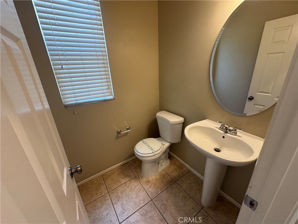 9757 Edenbrook Drive Riverside, CA 92503 - Photo 9 of 40 a bathroom with a toilet sink and mirror