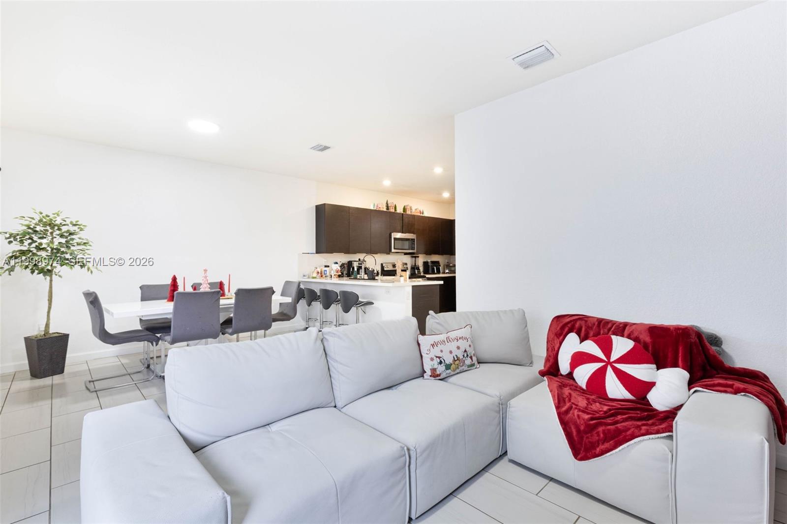 15070 Southwest 119TH Lane Miami, FL 33196 - Photo 12 of 30 a living room with furniture and a potted plant