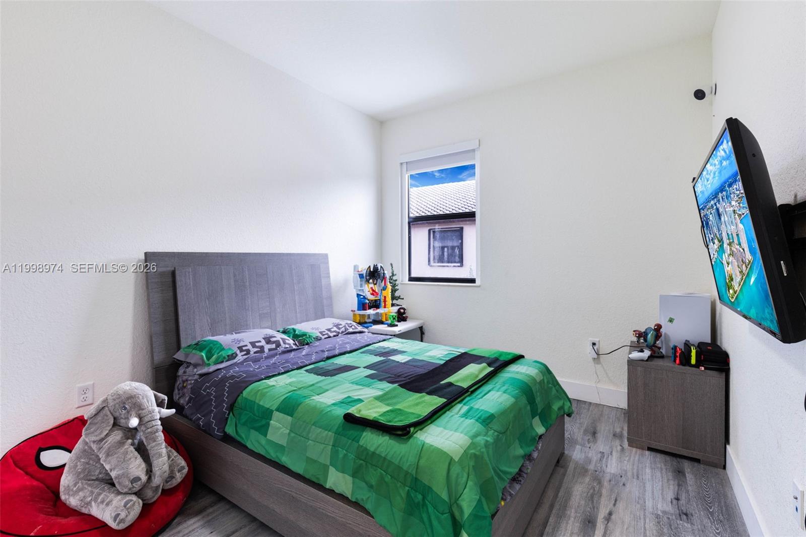 15070 Southwest 119TH Lane Miami, FL 33196 - Photo 15 of 30 a bedroom with a bed and a window