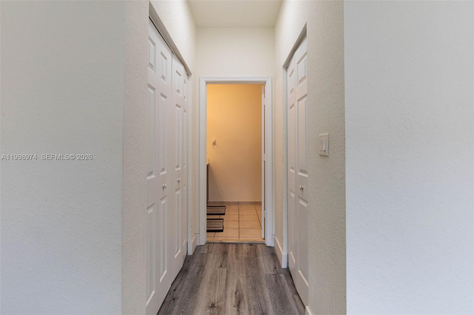 15070 Southwest 119TH Lane Miami, FL 33196 - Photo 18 of 30 a view of a hallway with wooden floor and a bathroom