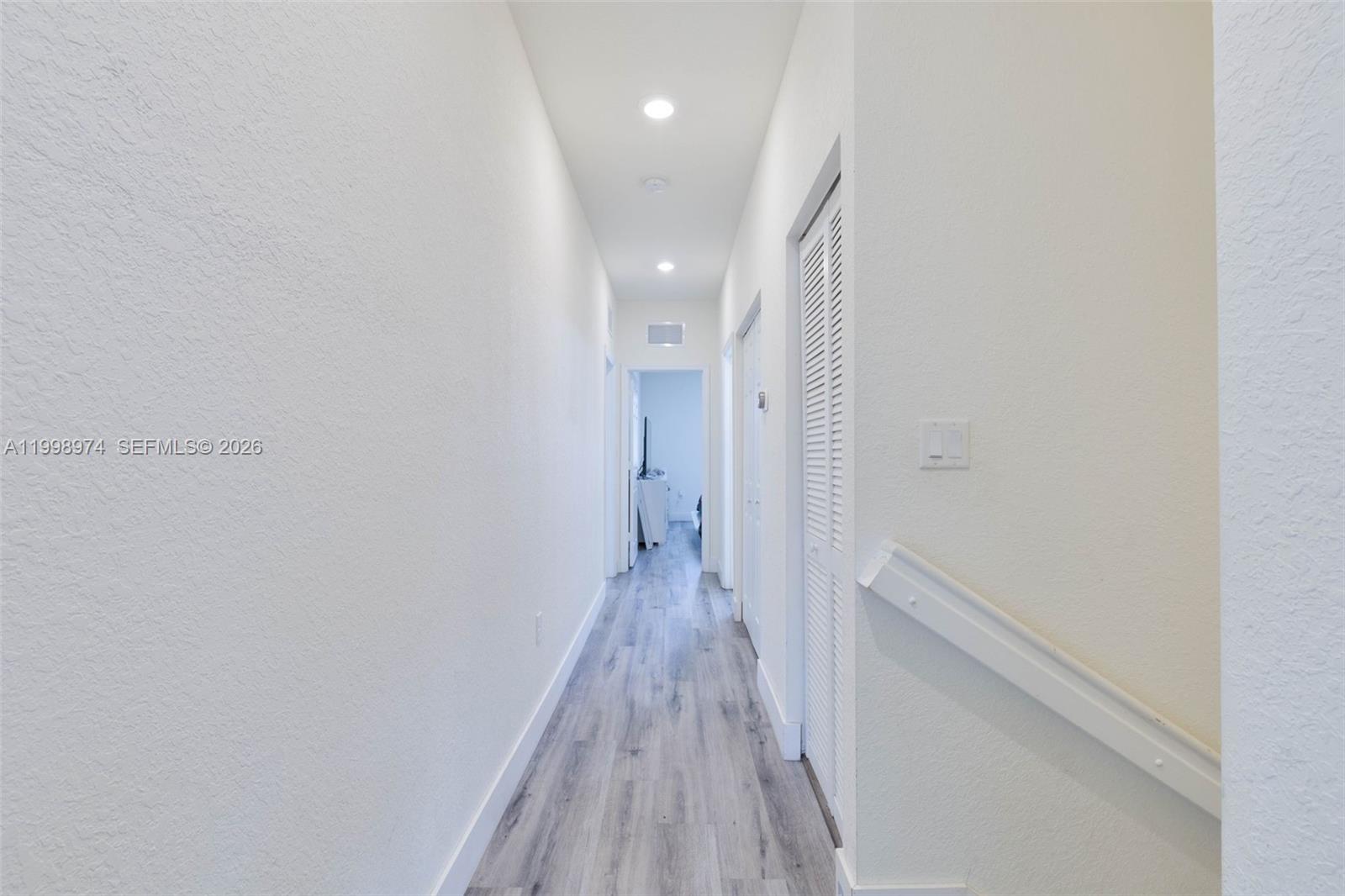 15070 Southwest 119TH Lane Miami, FL 33196 - Photo 21 of 30 a view of a hallway with wooden floor