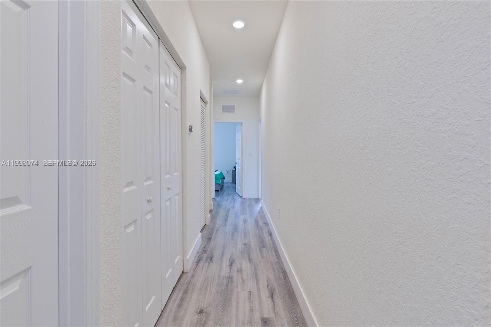15070 Southwest 119TH Lane Miami, FL 33196 - Photo 23 of 30 a view of a hallway with wooden floor
