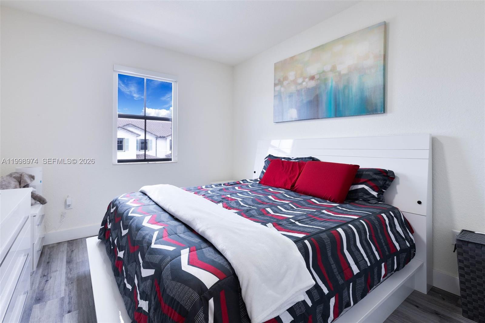 15070 Southwest 119TH Lane Miami, FL 33196 - Photo 24 of 30 a bedroom with a bed and a painting on the wall
