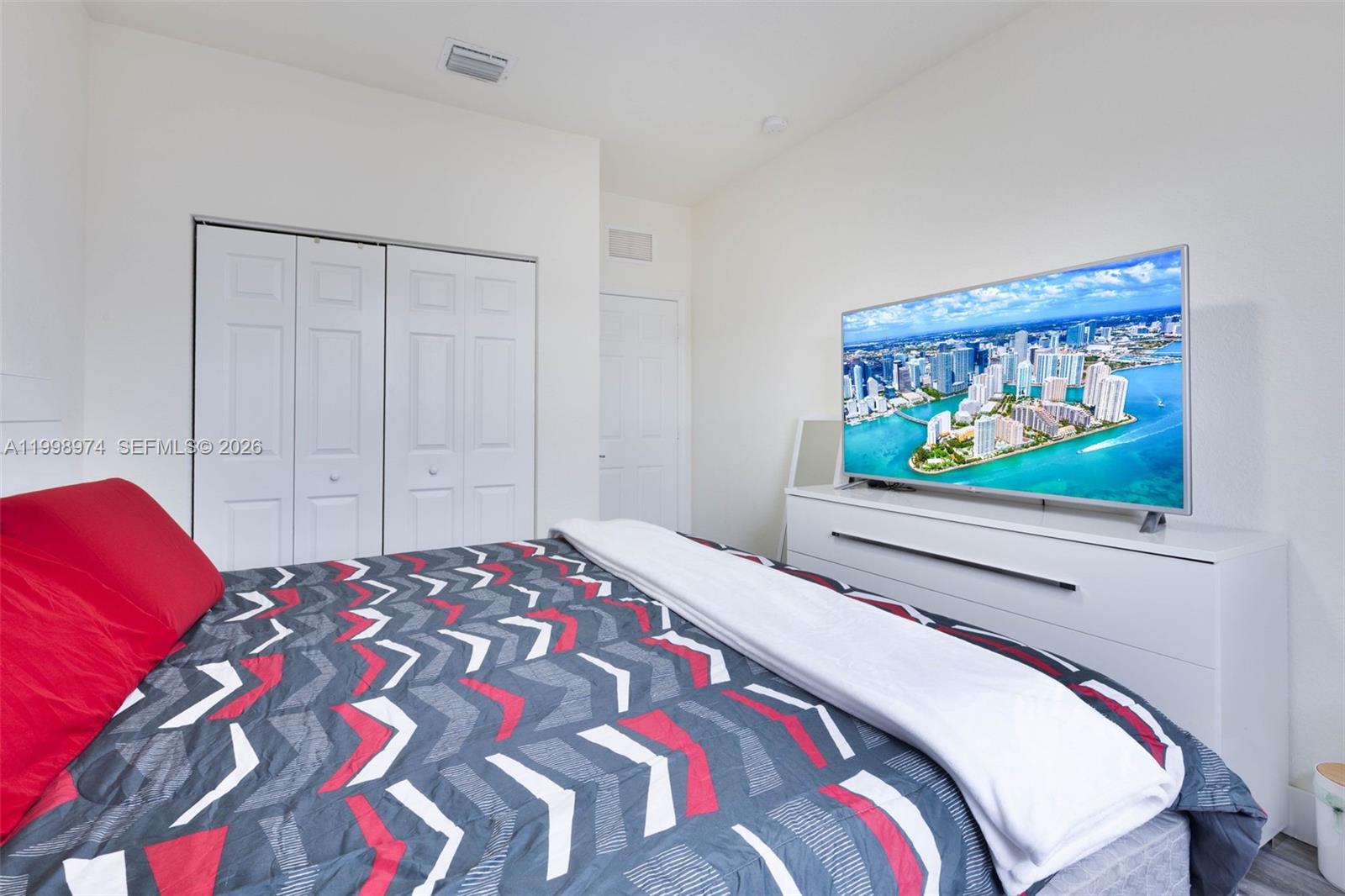 15070 Southwest 119TH Lane Miami, FL 33196 - Photo 25 of 30 a bedroom with a bed and a painting on the wall