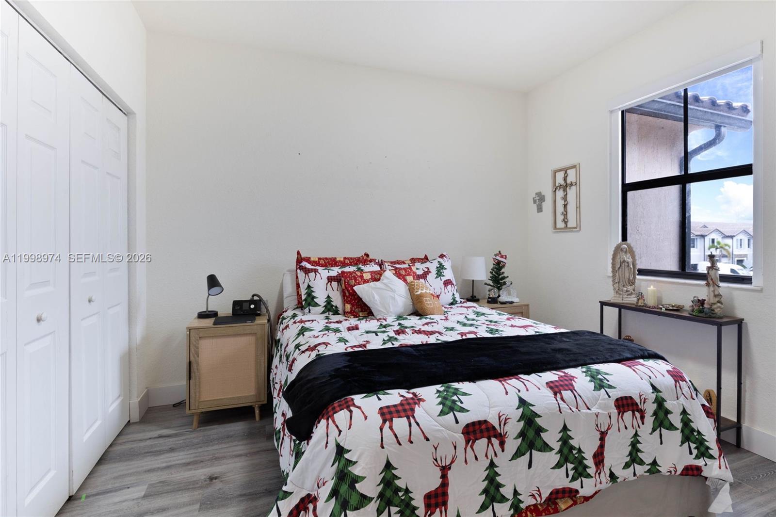 15070 Southwest 119TH Lane Miami, FL 33196 - Photo 26 of 30 a bedroom with a bed and wooden floor