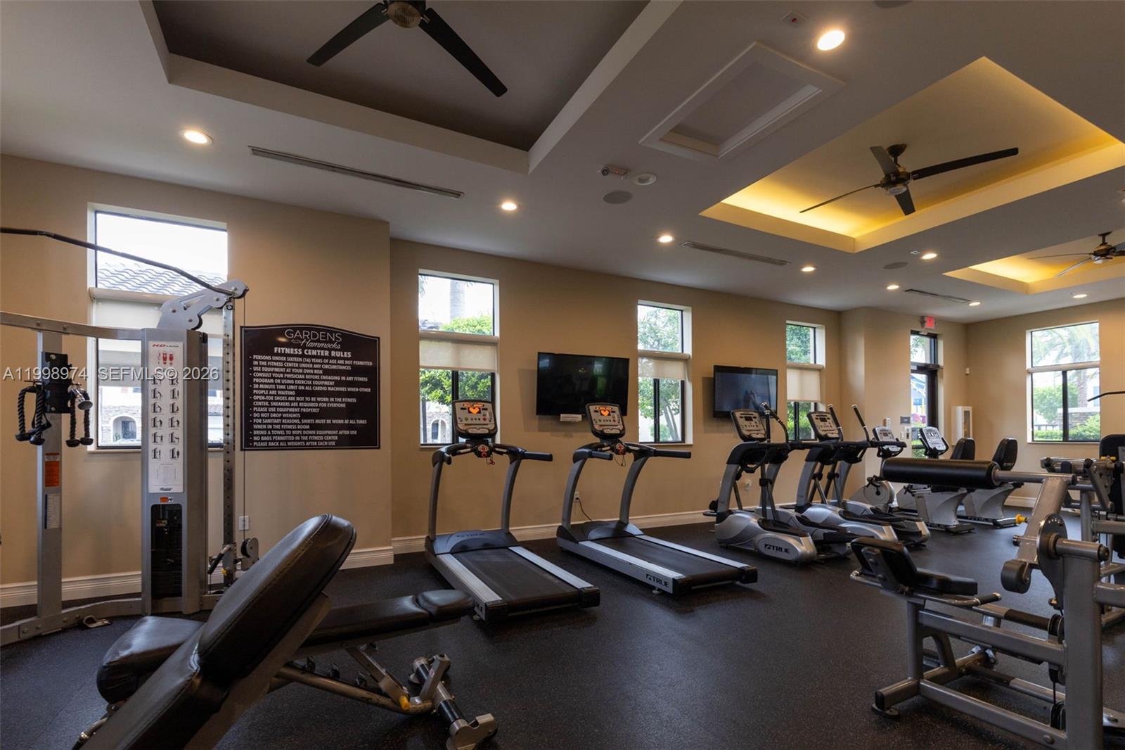 15070 Southwest 119TH Lane Miami, FL 33196 - Photo 28 of 30 a room with gym equipment and a flat screen tv