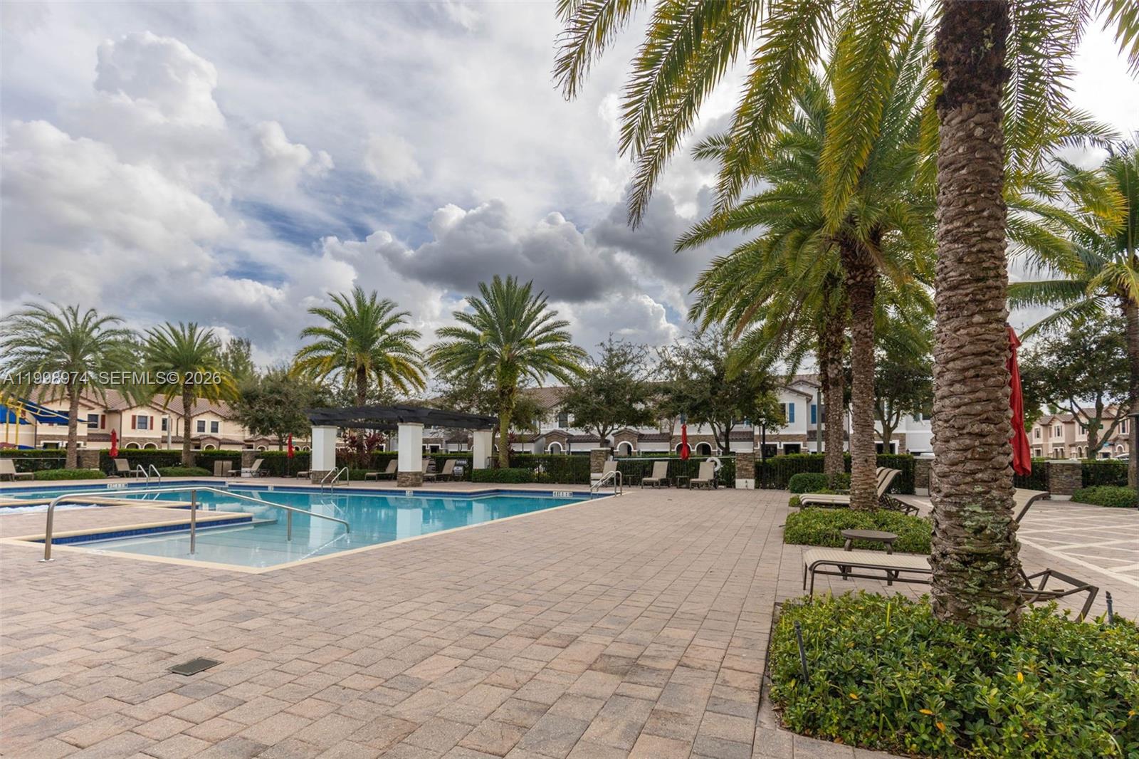 15070 Southwest 119TH Lane Miami, FL 33196 - Photo 29 of 30 a view of swimming pool with outdoor seating and plants