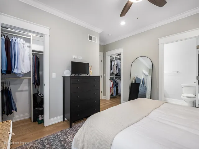 a bedroom with a bed and a television