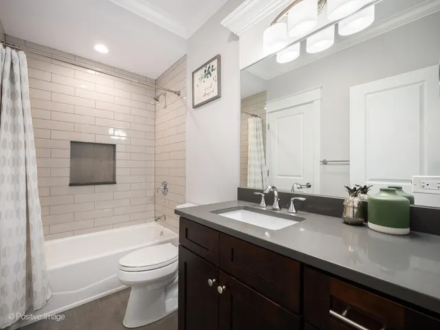 a bathroom with a double vanity sink toilet and shower