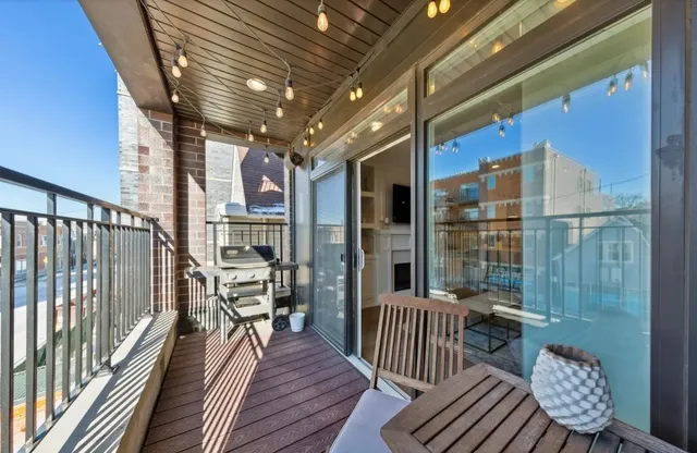 a view of a balcony with wooden floor