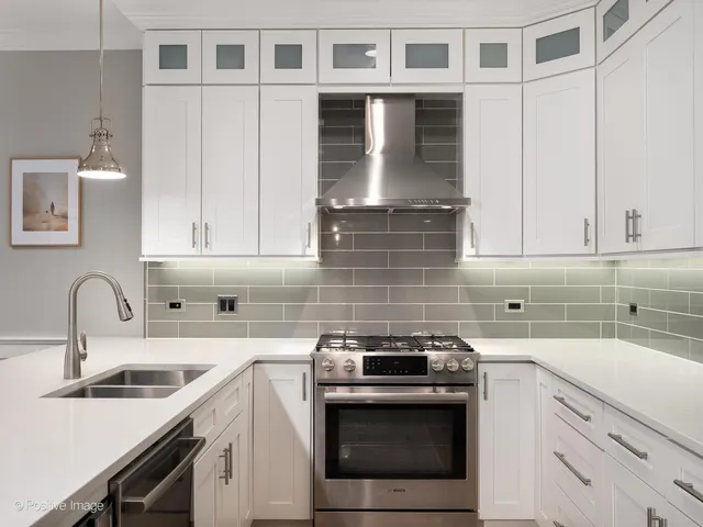 a kitchen with stainless steel appliances granite countertop a sink stove and cabinets