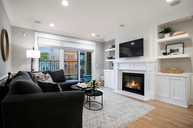 a living room with furniture a flat screen tv and a fireplace