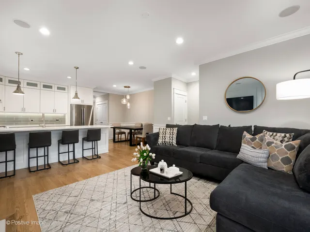 a living room with furniture and kitchen view