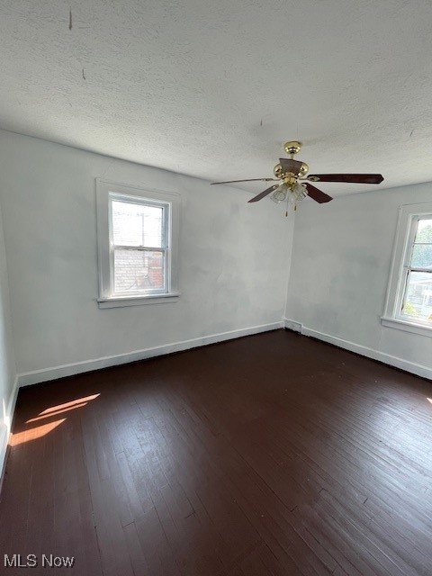 12612 North Road Cleveland, OH 44111 - Photo 12 of 15 Empty room featuring dark wood finished floors, baseboards, a textured ceiling, and a ceiling fan