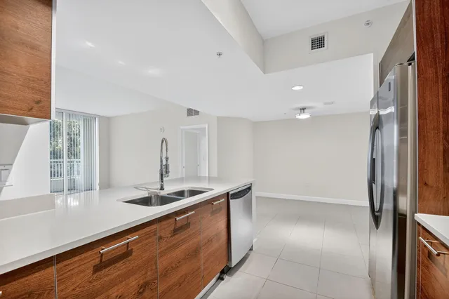 a kitchen with granite countertop a sink and a stove top oven