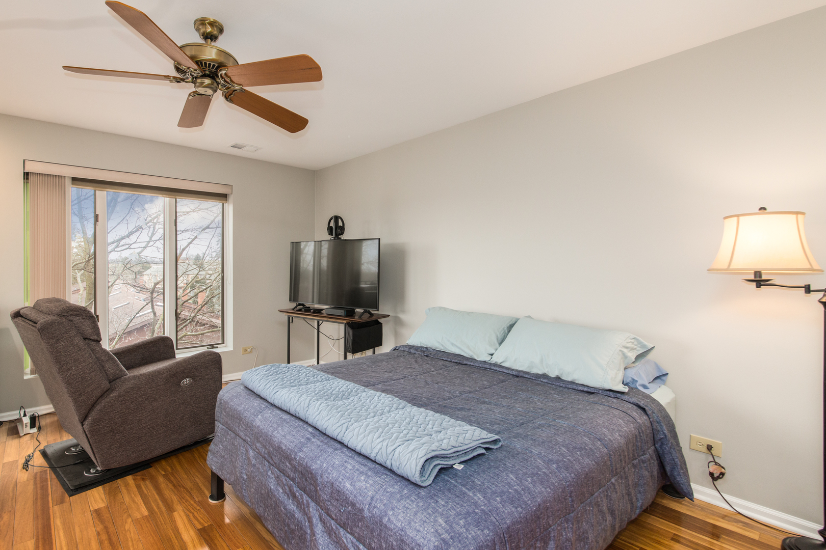 175 Boardwalk Place, Unit 301 Park Ridge, IL 60068 - Photo 12 of 20 a bedroom with a bed a couch and a ceiling fan