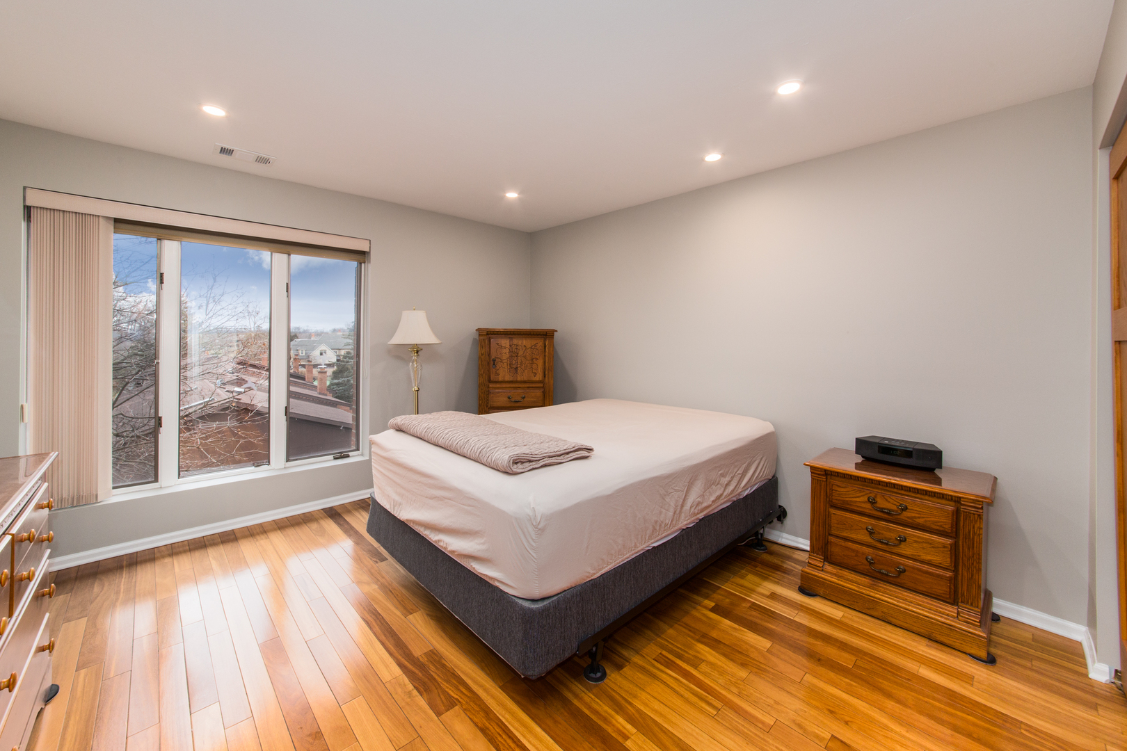 175 Boardwalk Place, Unit 301 Park Ridge, IL 60068 - Photo 17 of 20 a bedroom with a bed and wooden floor