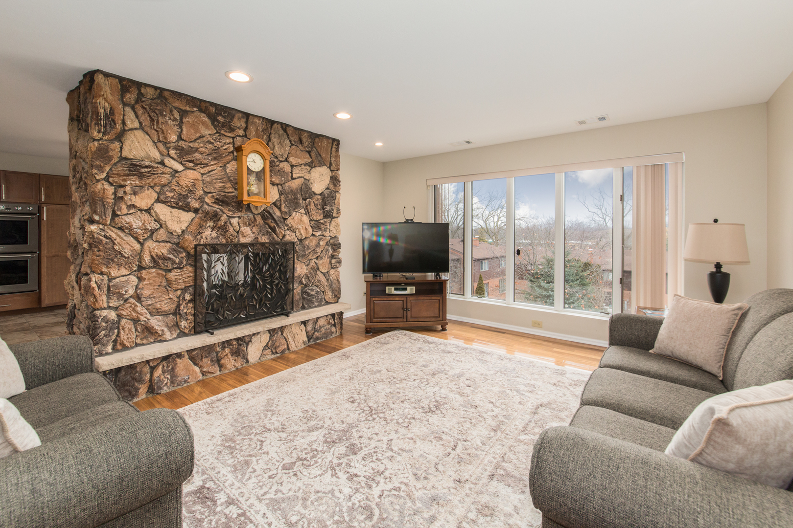 175 Boardwalk Place, Unit 301 Park Ridge, IL 60068 - Photo 2 of 20 a living room with furniture and a flat screen tv